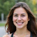 Happy client Sarah M. smiling, looking healthy and energetic after achieving her fitness goals.